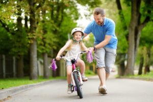 how to help a child to ride a bike